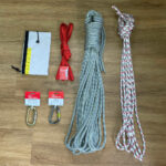 A photo of the sandstone ropework bundle featuring a 30m DMM statement rope, a 10m static line, a 240 sling, a DMM shadow screwgate, a DMM steel carabiner and a Lyon rope protector.