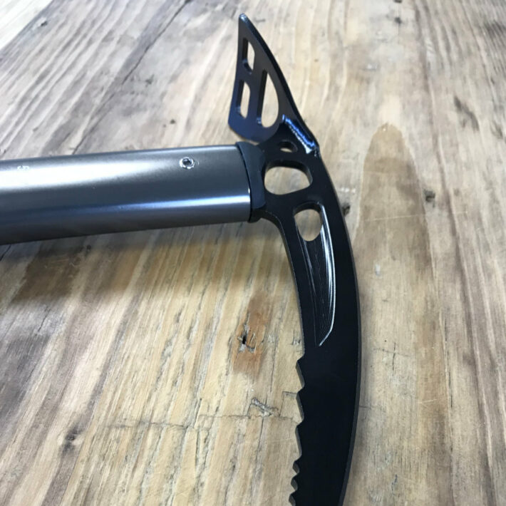 DMM Spire Tech Ice Axe, side-on perspective of the axe head where the adze, carabiner hole and part of the pick can be seen.