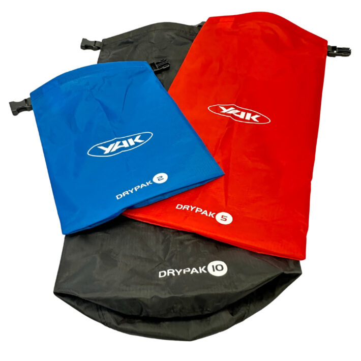 Yak lightweight Dry Bag Set, Yak lightweight Dry Bag Set, 10L, 5L, 2L, blue, red, grey, all stacked on top of eachover at angles