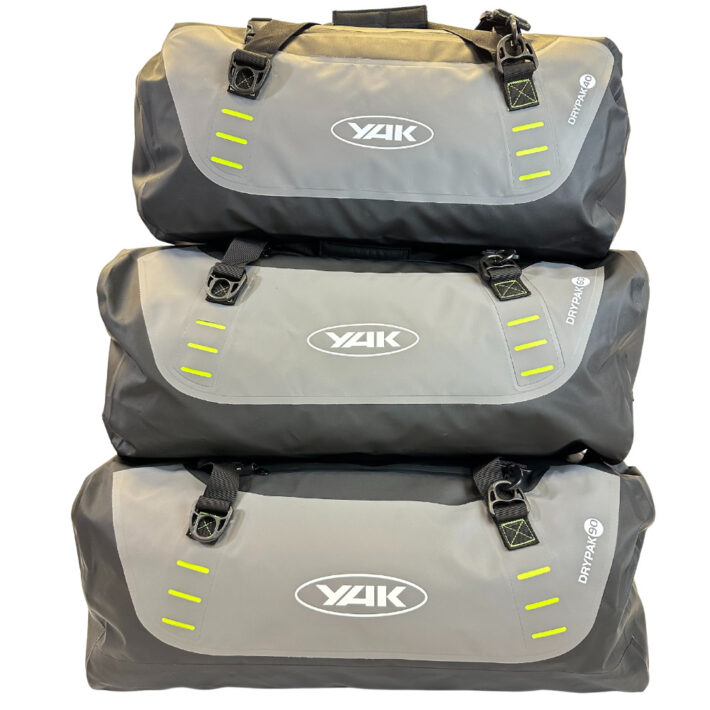 yak rolltop dry holdall selection, colours light and dark grey, showing front of all three sizes
